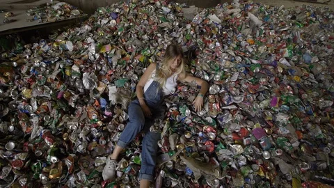 Laying down - Nature pollution activist at a huge trash dump - Young blonde Stock-Footage 120805336