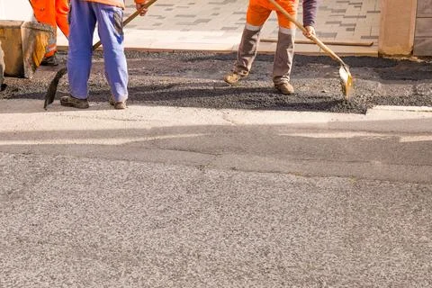 Laying down a new asphalt layer for a sidewalk Stock Photos