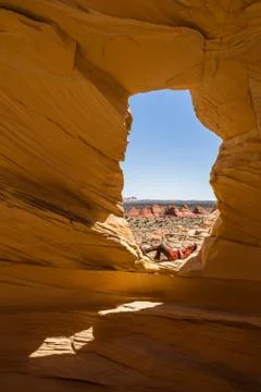 Laying down resting in the sun under an arch in the Coyote Buttes Wilderness Stock Photos