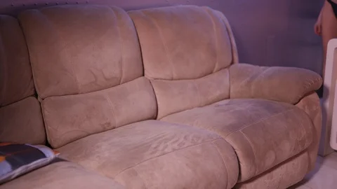 Laying down sofa: Attractive long hair hot blonde girl in violet blue neon light Video stock 122501261