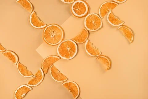Laying of dried oranges on red background Stock Photos