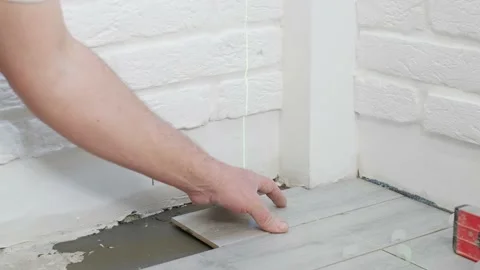 Laying floor ceramic tile. Renovating the floor. Stock Footage 171150411