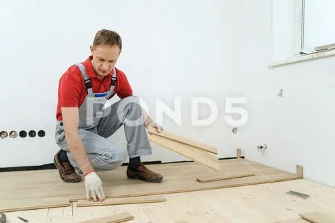 Laying hardwood parquet. Stock Photos