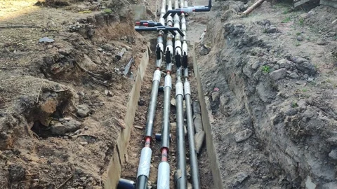 Laying a heating main pipe system underground. Replacement of old heating main Stock Footage 255636427