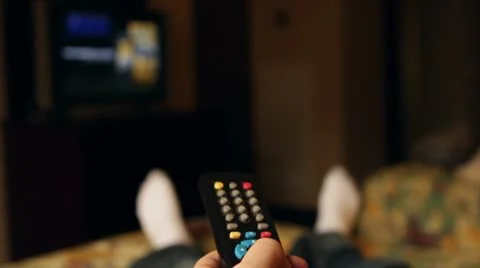 Laying in hotel bed flipping through channels Stock Footage 10900632