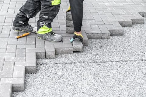 Laying interlocking pavers during the construction of sidewalks and roads Stock-Fotos