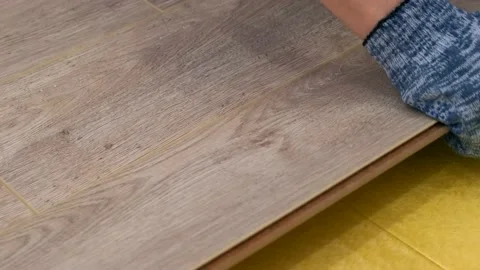 Laying laminate flooring in close-up. Technology and process. Floor repair Stock Footage 147952934