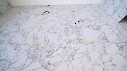 Laying Marble Tiles with Leveling System 库存照片