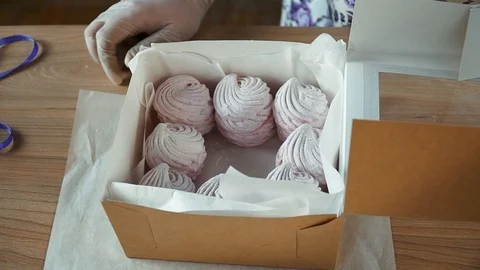 Laying marshmallows in a box 2 Stock Footage 85666973