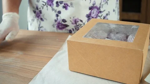 Laying marshmallows in a box 4 Stock Footage 85666974