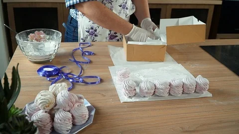 Laying marshmallows in a box. Stock Footage 85666943