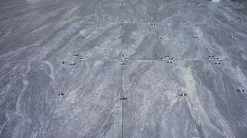 Laying new grey marble floor tiles with leveling system in modern interior space Stock Footage 345665604