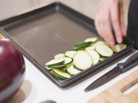 Laying out cucumber slices on a pan Stock Footage