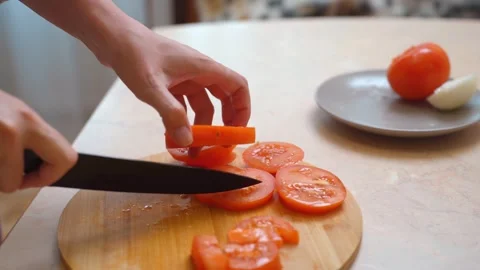 Laying out fresh chopped tomatoes on rustic wooden serving tray Stock Footage 329059979