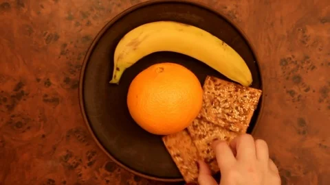 Laying out fruit and crackers for breakfast, top view Stock Footage 83273825