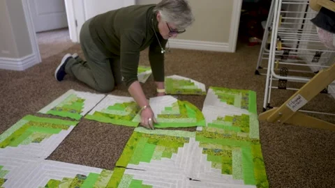 Laying out large quilt blocks before sewing them together - time lapse Stock Footage 171453593