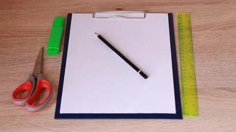 Laying out writing accessories on table Vídeo Stock 86231174