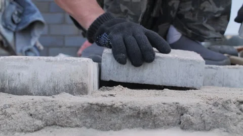 Laying paving blocks on sand base during construction Video stock 311592148