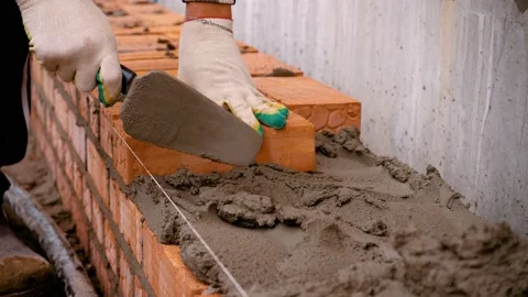 Laying red bricks. Brick wall construction Vidéo 220341543