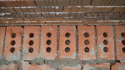 Laying of red bricks. Profesional worker builds an expensive red brick house Stock Photos