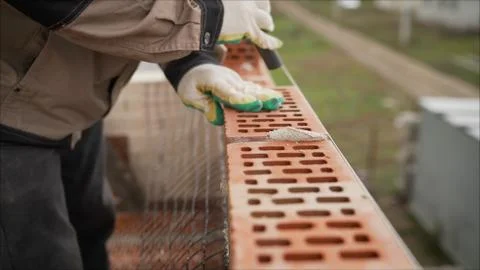 Laying of red bricks. Profesional worker builds an expensive red brick house Stock Photos