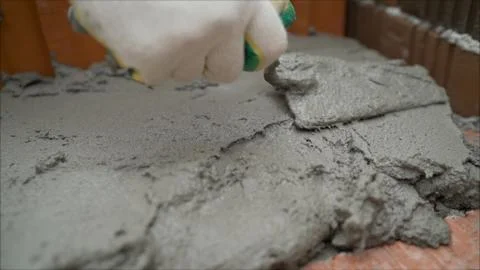 Laying red ceramic blocks at a construction site. CERAMIC BLOCKS FOR BUILDING A Stock Photos