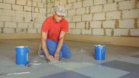 Laying rubber floor tiles Stock Footage 79337488