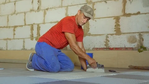 Laying rubber floor tiles Stock Footage 79338244