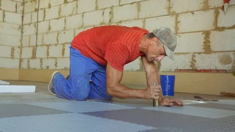 Laying rubber floor tiles Stock Footage 79338365