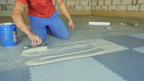 Laying rubber floor tiles Stock Footage 79338732