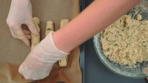 Laying shaped sausages on a baking sheet Stock Footage 249268136