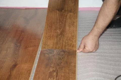 Laying a sheet of laminate Stock Photos