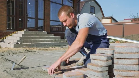 Laying stone pavers master Stock Footage 80392073
