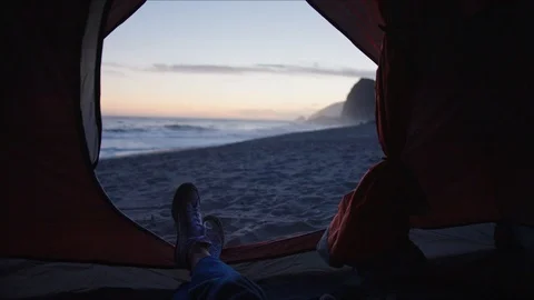 Laying in tent with view of sunset on ocean coast Vidéo 127409274