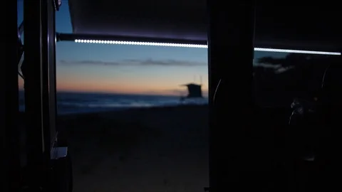 Laying in tent with view of sunset on ocean coast Vidéo 127409430