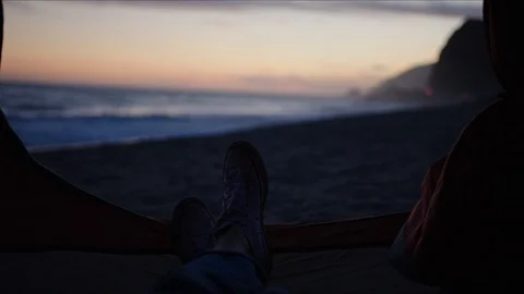 Laying in tent with view of sunset on ocean coast Stock-Footage 127409481