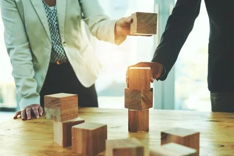 Laying their success on a solid and stable foundation. two unrecognisable Stock Photos