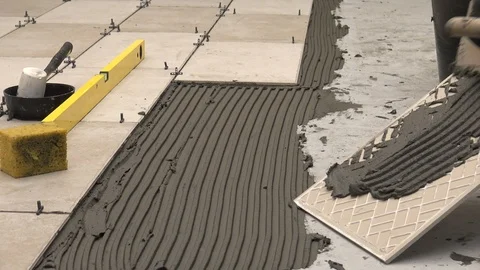 Laying a tile with cement adhesive Stock Footage 111867020