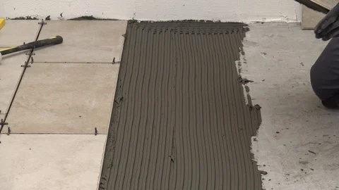 Laying tiles on the floor Stock Footage 111867046