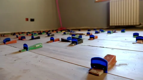 Laying the tiles on the floor using the self levelling spacers Stock Footage 147218049