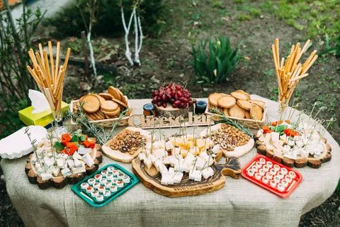 Laying of various cheeses on a large table in the open air. Stock Photos