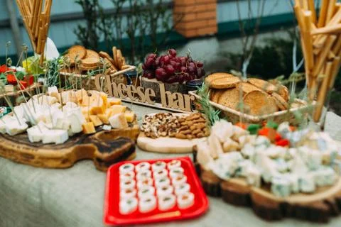 Laying of various cheeses on a large table in the open air Stock Photos