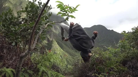 Layout Backflip on Lush Jungle Mountaintop Stock Footage 82352738