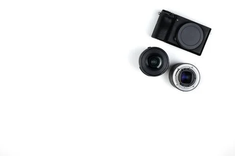 The layout is a black mirrorless camera with lenses on a white background. Stock Photos