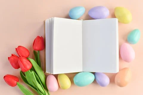 Layout of a book, Easter eggs and a bouquet of tulips Stock Photos