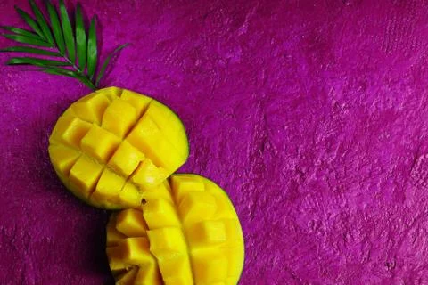 The layout on a bright crimson background. Mango in the form of a trunk of a  Stock Photos