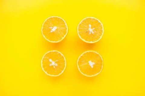 Layout of bright orange oranges on a bright yellow background. Stock Photos
