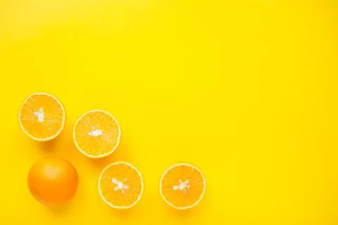 Layout of bright orange oranges on a bright yellow background. Stock Photos