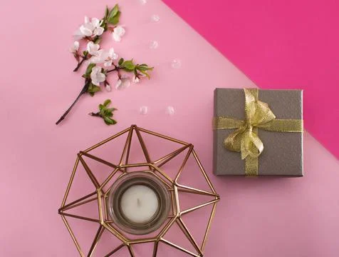 Layout. candle, a packed gift box, a tree branch blooming with flowers. Stock Photos