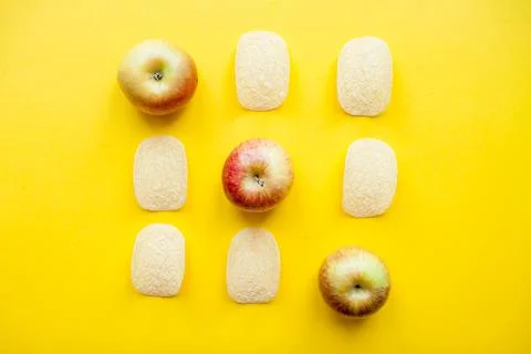A layout of chips and apples in the form of a tic-tac-toe game. Weight loss and Stock Photos